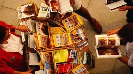 People browsing through maps and guides for sale. People browsing through maps and guides for sale.