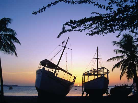  Yet another glorious sunset silhouettes wooden boats on Isla de Margarita