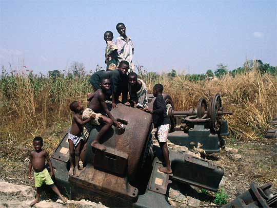  Children pose amid the rust, in countryside near Tohoun