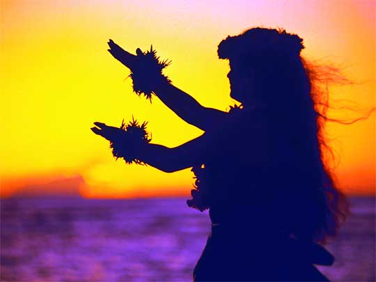 Lone hula dancer at sunset on Waikiki Beach