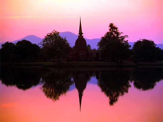  Sunset over the ancient stupas of Sukothai Historical Park