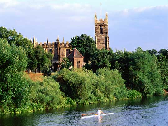  Sculler rowing on the River Trent in front of Wilford Church