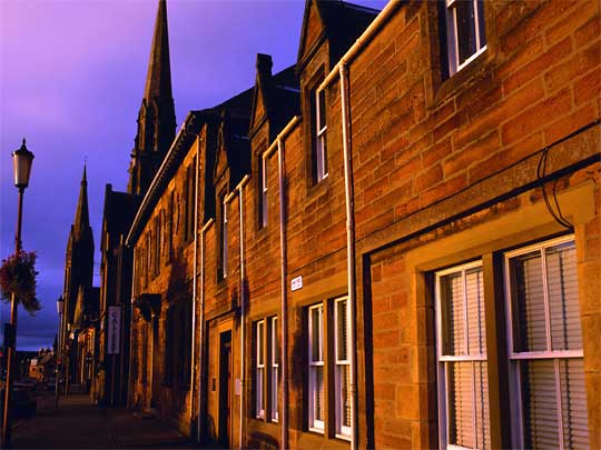  Sunlit facades of houses in Inverness