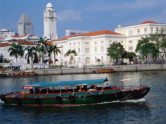 Tourist barge on Singapore River, with Empress Place Building in background