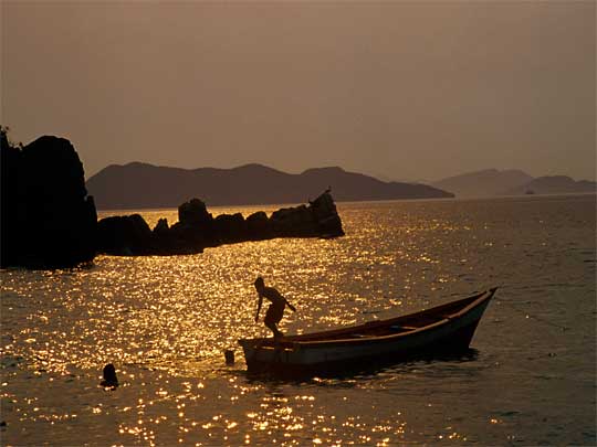  Like a scene from Karate Kid : sunset silhouettes boy and boat, Playa Colorada 