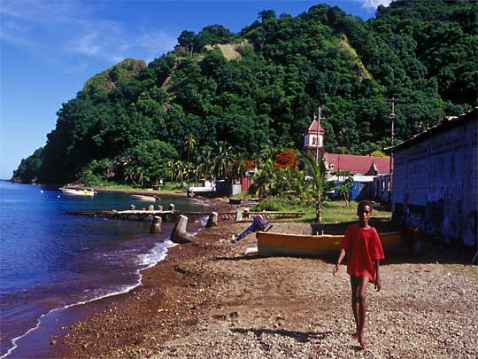  Boy runs at photographer in fishing village of Soufriere, South Coast