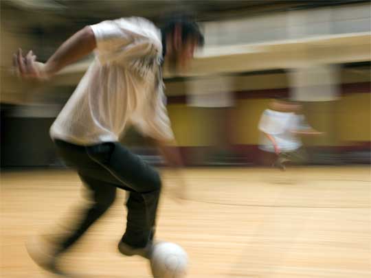  Two men in motion playing soccer