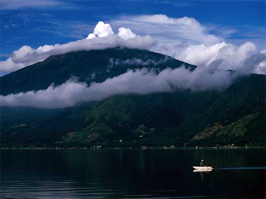  Away from it all: man rowing boat on pristine Lake Coatepeque