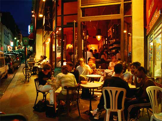 Streetside dining at night in a cafe in Pigalle