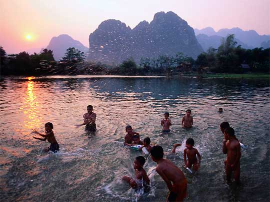  Children playing in Song River, Vang Vieng, southern central Laos