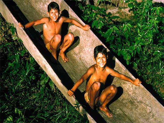  Boys boating on dry land in a traditional dugout canoe