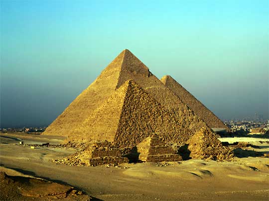  Pyramids Mycerinus, Chephren and Cheops at Giza, with Cairo suburbs as background