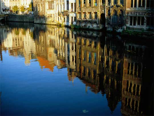  Buildings reflected in the still waters of a canal
