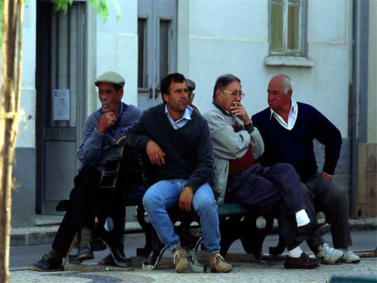  Alvor menfolk contemplate the passing of the afternoon in the town centre.