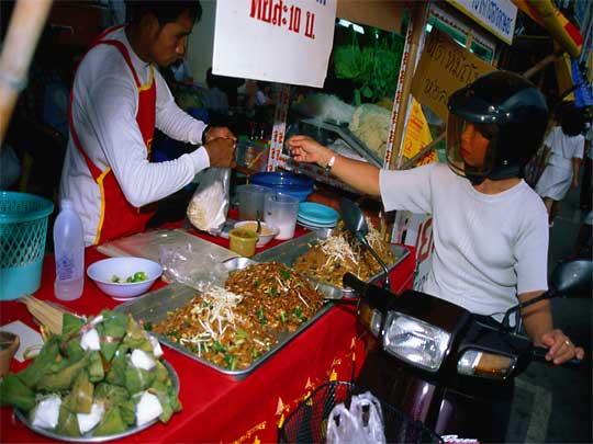 Scooter noodles on the go in Phuket Town