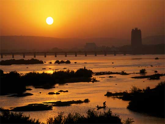  Niger River at sunset with distinctive silhouette of BCEAO bank in background
