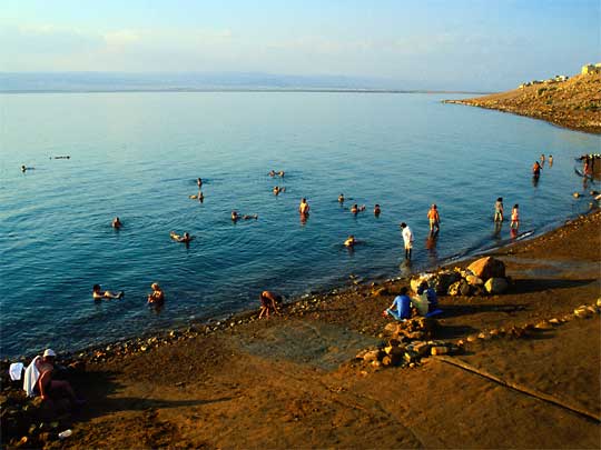  Tourists around Dead Sea, some of them floating, western Jordan