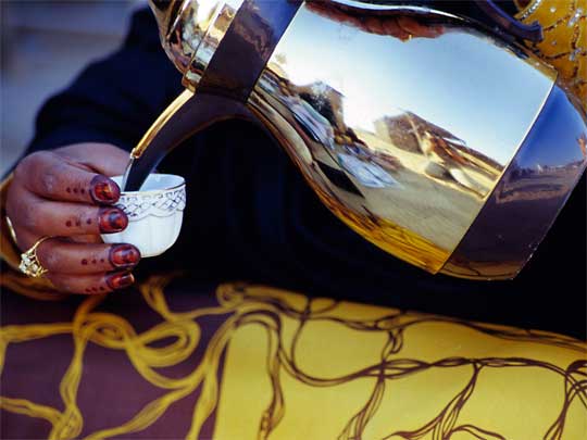  Painted fingers pouring Arabic coffee