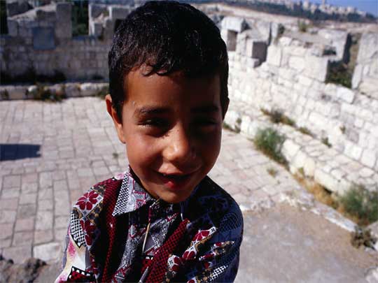  Palestinian boy on ramparts of Muslim Quarter, Old City