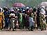Women and children, with umbrellas and branches, Lomé