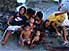 Group of children playing on shore.