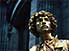 A golden statue contemplates life in the city of light