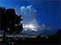 Hilltop view of San Salvador at dusk during an electrical storm