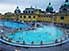 Happy denizens relax in naturally-heated outdoor pools at the Szechenyi Baths