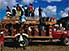 People on roof of sideless red bus in Port-au-Prince, Haiti's capital city