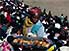 Woman selling pastries at Independence Day rally, Antananarivo (Tana)