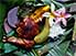 Roast pork with mango, served on banana leaves, with decorative fragipani