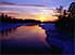 Sunset over partly frozen river in Oulanka National Park, north eastern Finland